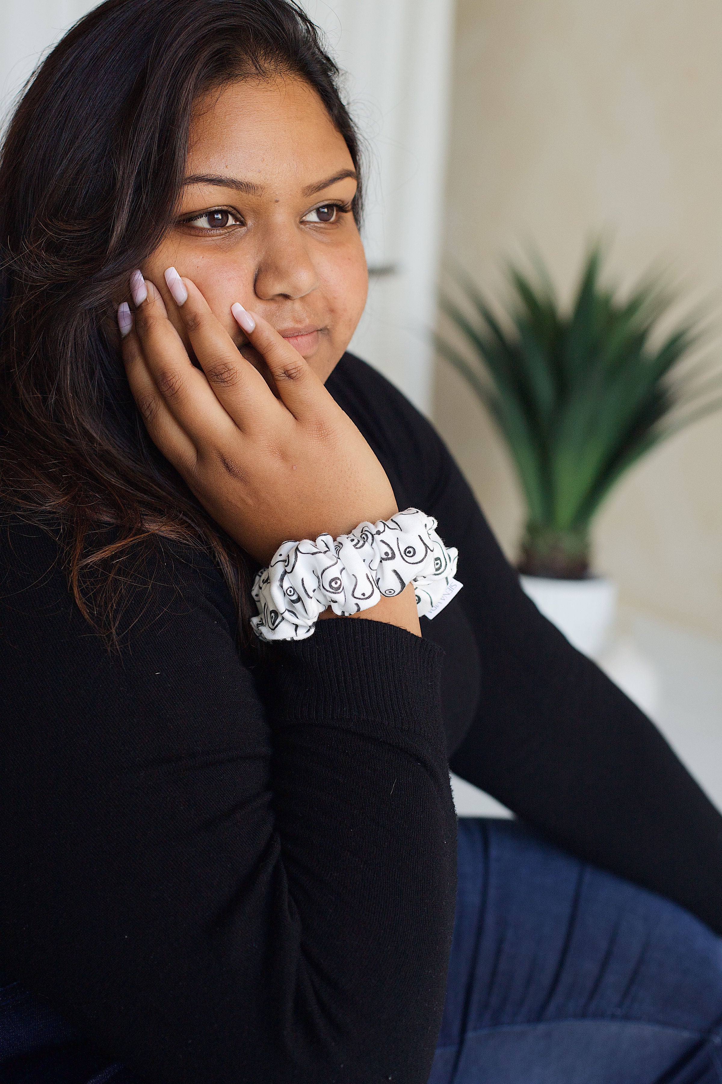 Siena Vida Boob scrunchie on model's wrist. Handmade in Toronto with 100% Organic Cotton. Eco-friendly scrunchie.