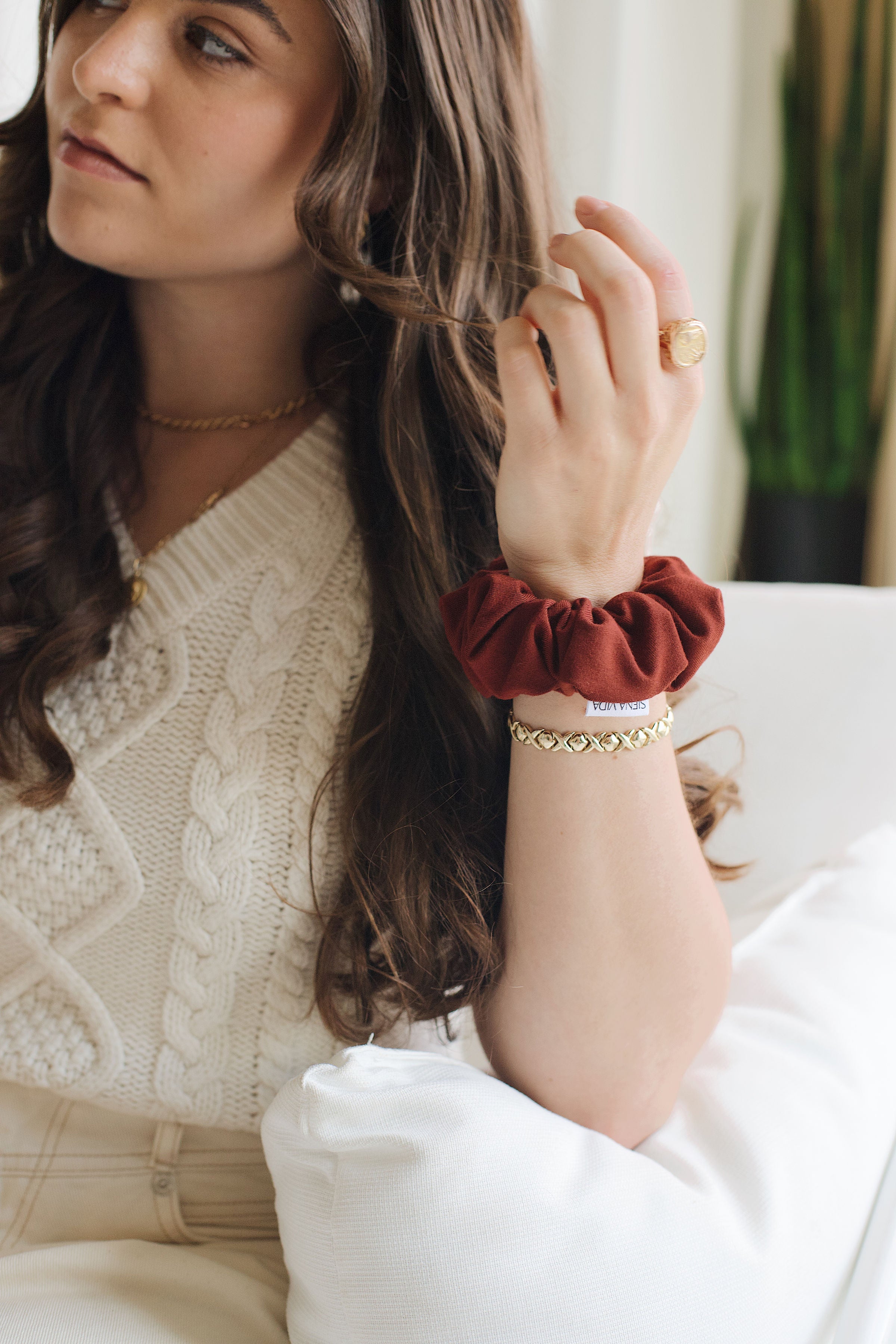 Bright, vibrant red scrunchie on model's wrist